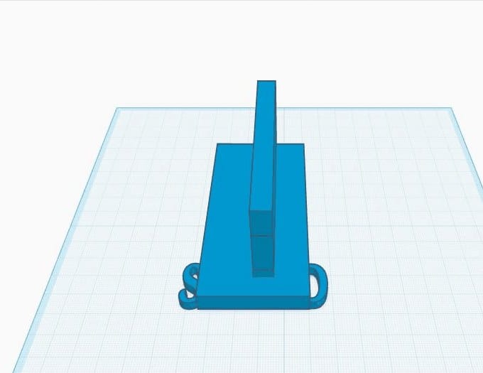 The finished phone and cable stand: a base plate, an upright backrest wall, and a name on the front