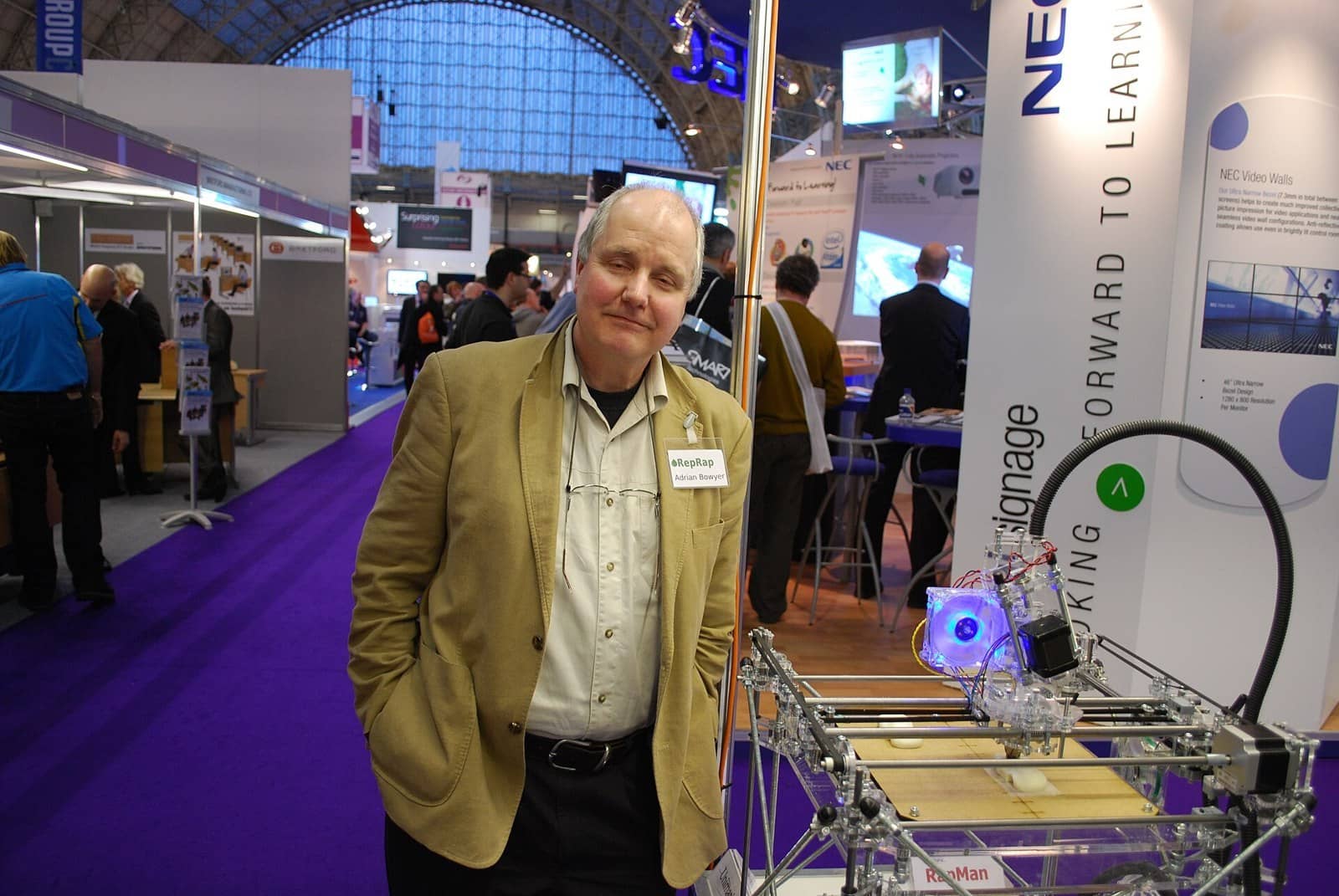 Adrian Bowyer standing next to a RapMan RepRap-kit printer