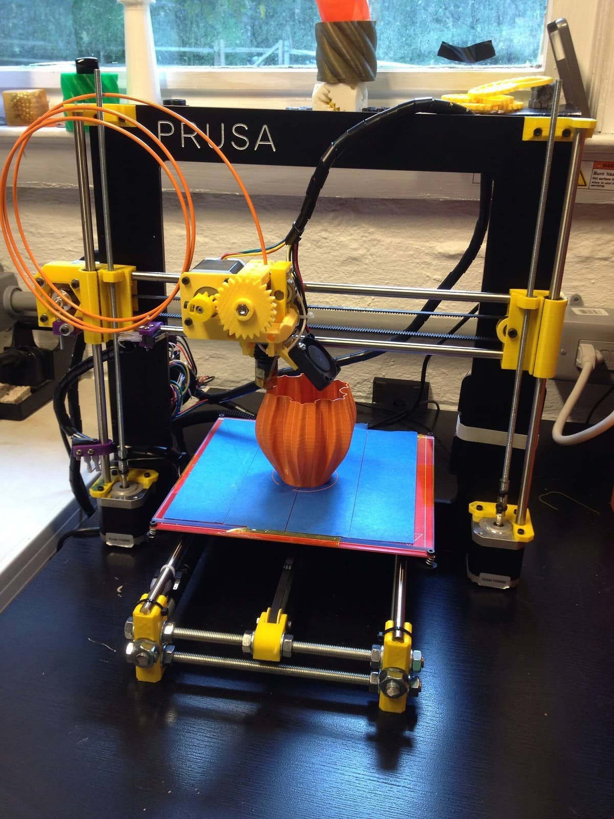 A Prusa i3 3D printer printing a vase