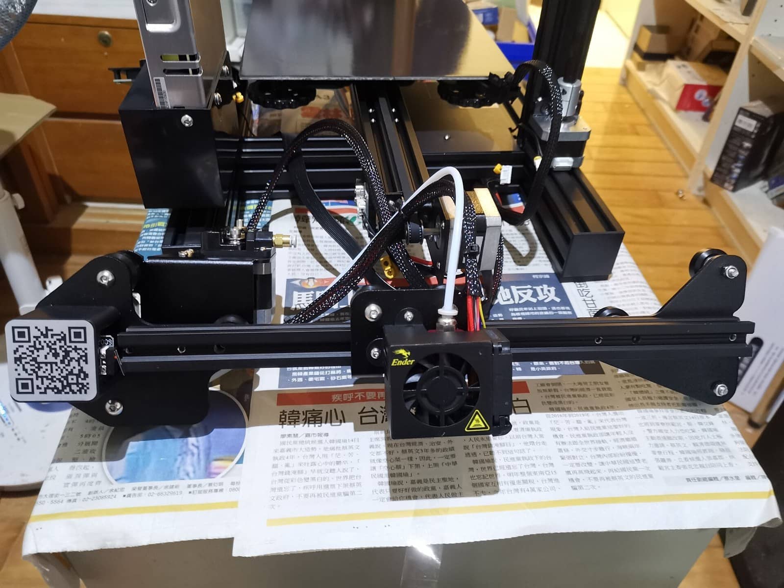 A Creality Ender-3 part-way through assembly, showing the bed carriage, the hot end and the Z motor